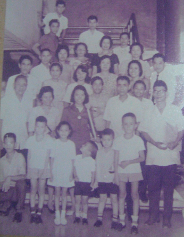 6 Rolly, in white shirt alone top first row, with family and friends seeing off sis his sister Chay , August 3 1966, for an ascholarship grant in the U.S., the first in the family to set